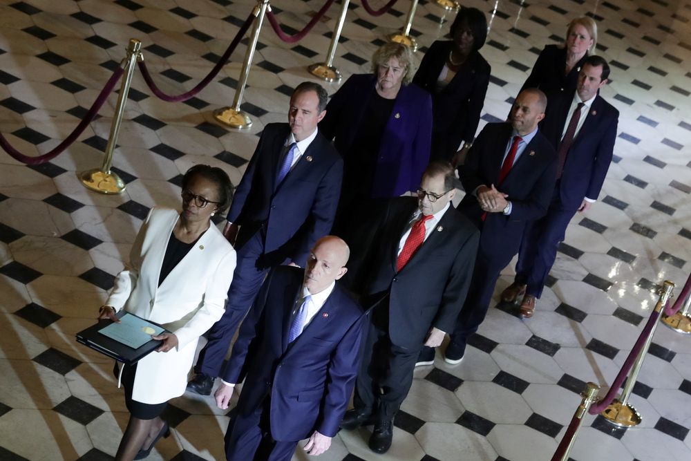 US House of Representatives Clerk Cheryl Johnson and House Sergeant at Arms Paul Irving carry two articles of impeachment against US President Donald Trump during a procession with the seven US House impeachment managers through Statuary Hall in the US Ca