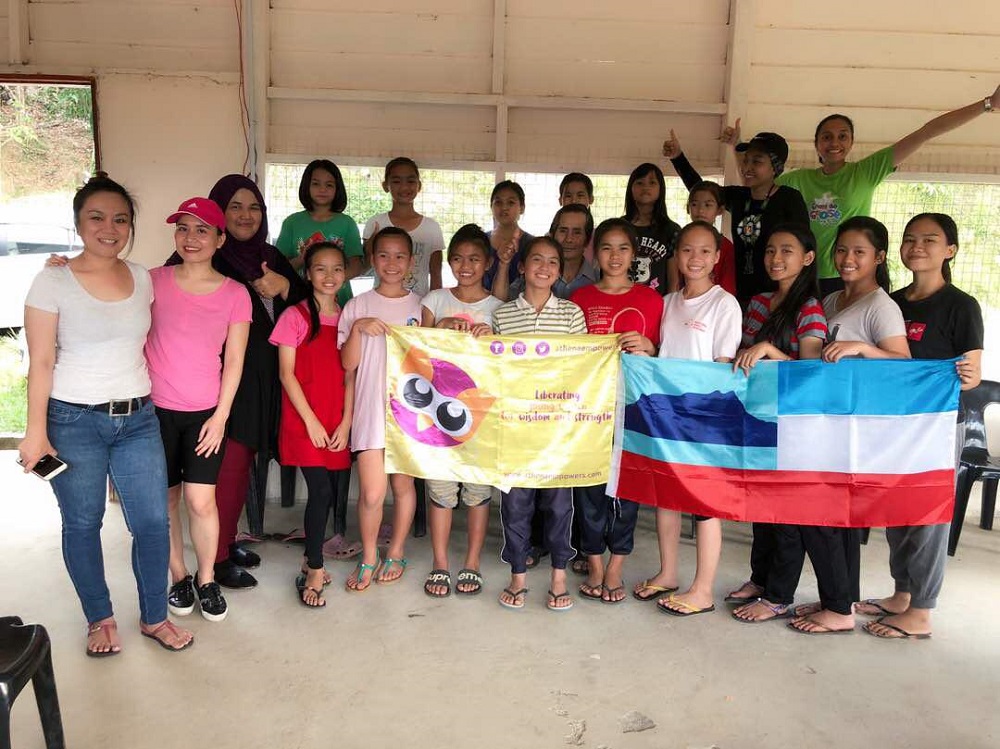 Anja (third from left) posing with girls from Kampung Melangkap in Kota Belud, Sabah during a menstrual hygiene management workshop in August 2018. — Picture courtesy of Anja Juliah Abu Bakar