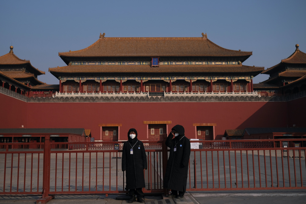 Security personnel wearing protective masks stand at the main entrance of the Forbidden City where a notice is seen saying that the place is closed to visitors for the safety concern following the outbreak of a new coronavirus, in Beijing, China January 2