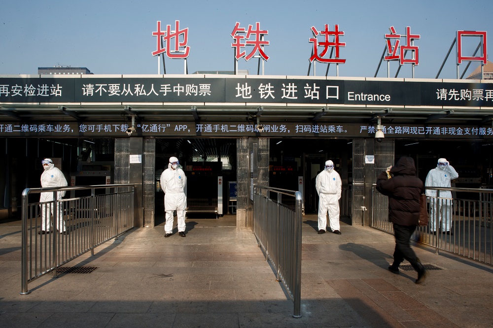 Workers take the body temperature of passengers before they enter the subway station outside the Beijing Railway Station in central Beijing  January 25, 2020. u00e2u20acu201d Reuters pic 