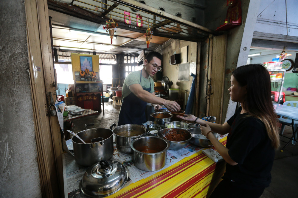 Look out for the pork nasi lemak stall hidden at the back of the market. — Picture by Ahmad Zamzahuri
