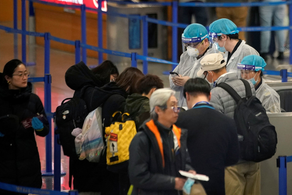 Medical officials are seen as passengers leave at the Pudong International Airport in Shanghai, China January 27, 2020. u00e2u20acu201d Reuters pic