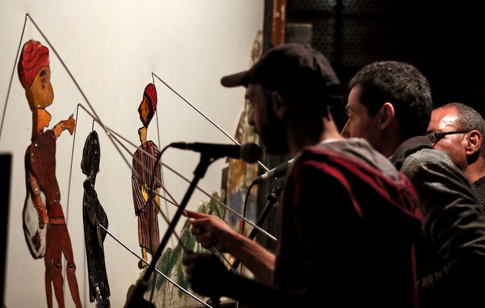 Members of Egypt’s Wamda troupe manipulate puppets during a Aragoz puppets show in Beit al-Sehemi, in Cairo’s Gamaliya district November 15, 2019. — AFP pic