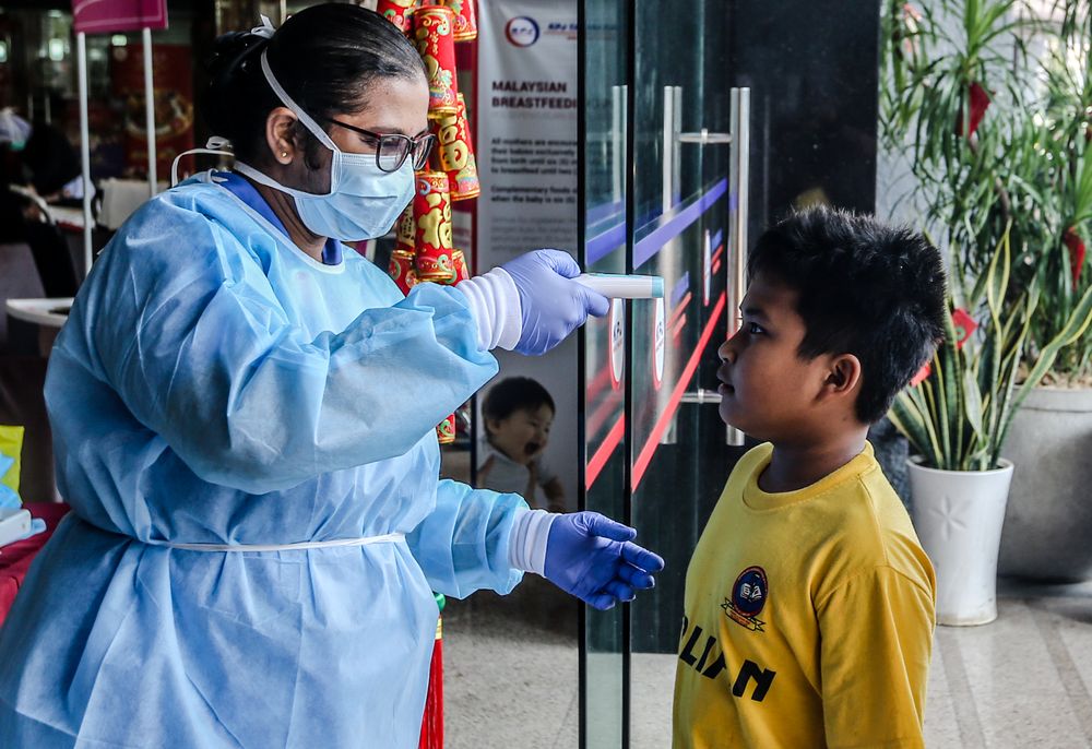 Medical personnel check the temperature of a visitor at the entrance of KPJ Tawakkal hospital in Kuala Lumpur, January 28, 2020. u00e2u20acu201d Picture by Firdaus Latif