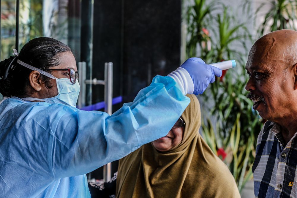 Medical personnel check the temperature of a visitor at the entrance of KPJ Tawakkal hospital in Kuala Lumpur, January 28, 2020. u00e2u20acu201d Picture by Firdaus Latif