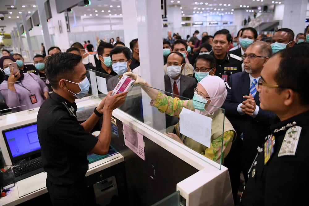 Deputy Prime Minister Datuk Seri Dr Wan Azizah Wan Ismail distributes face masks to immigration officers at KLIA2 in Sepang January 29, 2020. u00e2u20acu201d Bernama pic
