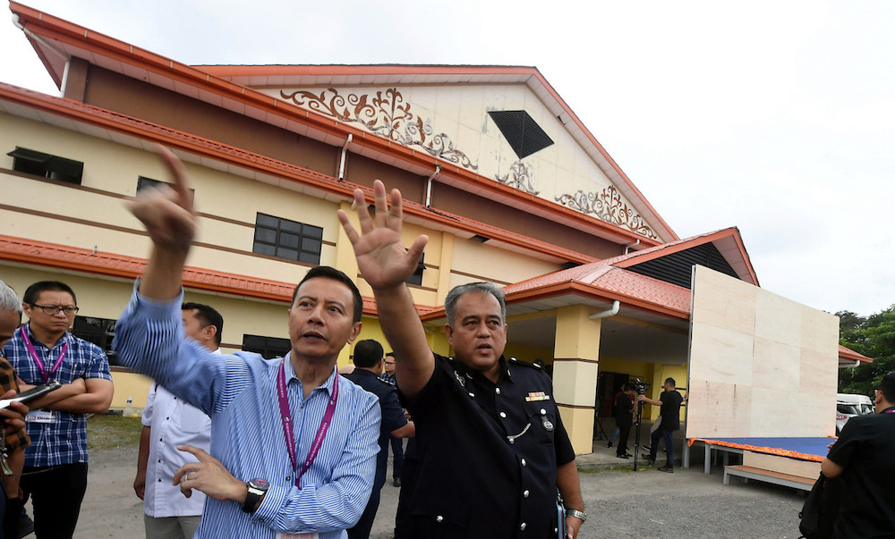 EC chairman Datuk Azhar Azizan Harun and Beaufort district police chief DSP Azmir Abdul Razak visit the nomination centre in Kimanis January 3, 2020. u00e2u20acu201d Bernama pic