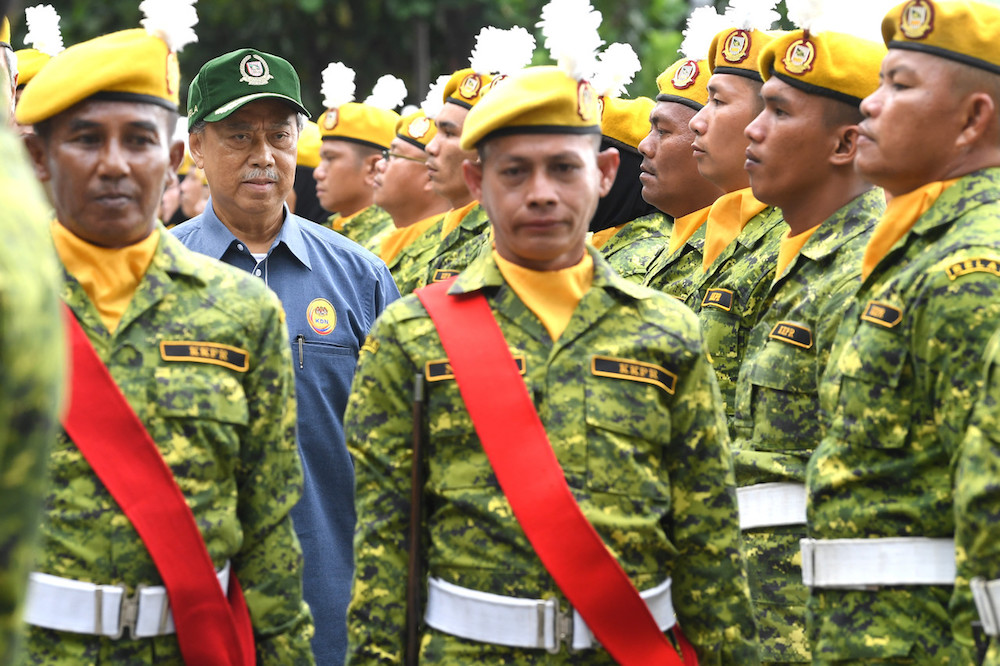Tan Sri Muhyiddin Yassin inspects a guard of honour by Rela members in Papar January 11, 2020. u00e2u20acu201d Bernama pic
