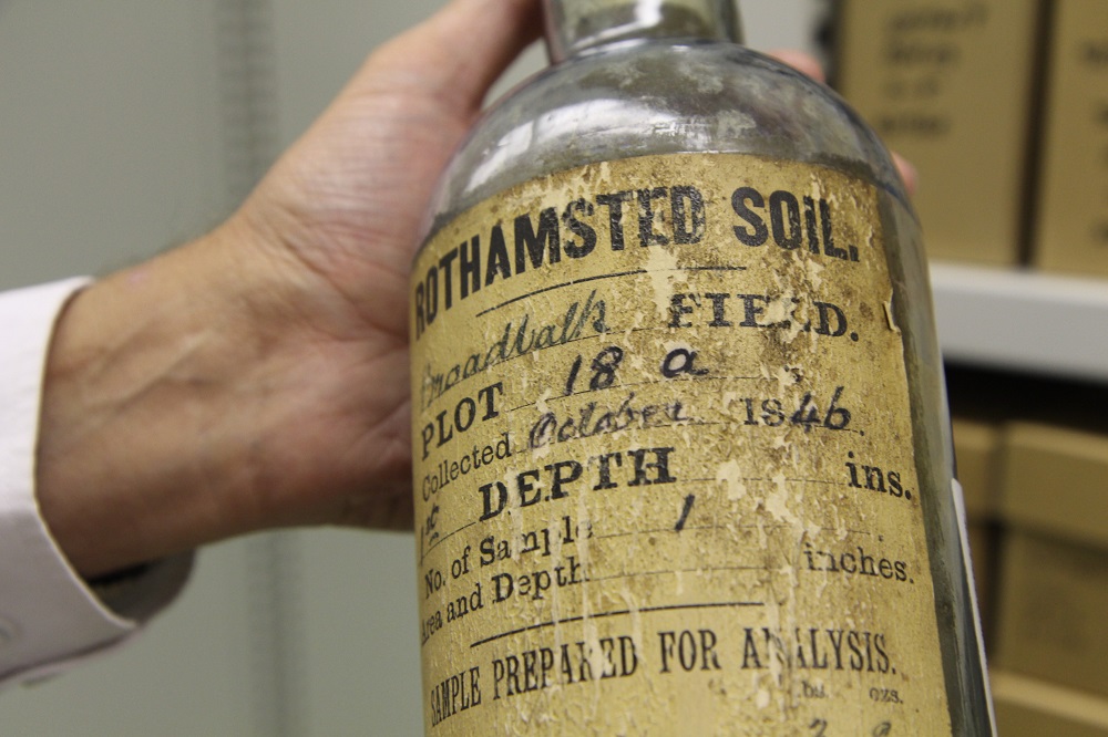 A scientist at Rothamsted Research holds a glass bottle with soil sample dating back to October 1846 in Harpenden in south east England September 12, 2019. u00e2u20acu201d Thomson Reuters Foundation pic
