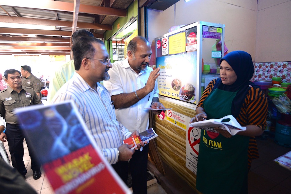 Communication and Multimedia Minister Gobind Singh Deo talking to a stall owner at the Lorong Kulit hawker centre in Penang January 30, 2020. u00e2u20acu201d Picture by Steven Ooi KE