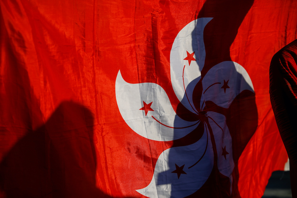 A shadow is cast on a Hong Kong flag as Hongkongers gather before a soccer match between Hong Kong and China outside Busan Asiad Stadium in Busan, South Korea, December 18, 2019. u00e2u20acu201d Reuters picnn