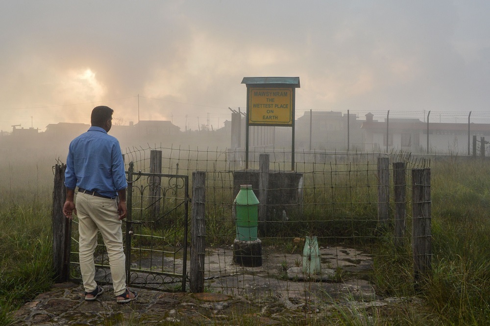 This picture taken on September 20, 2019 shows a man standing near a board reading u00e2u20acu02dcThe Wettest Place On Earthu00e2u20acu2122 at Mawsynram in the northeastern Indian state of Meghalaya. u00e2u20acu201d AFP pic   