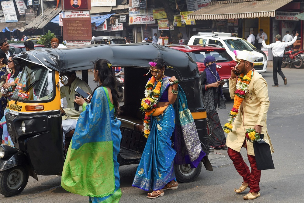 In this photograph taken on December 24, 2019, a bride and groom arrive at a marriage hall in Mumbai. u00e2u20acu201d AFP pic 