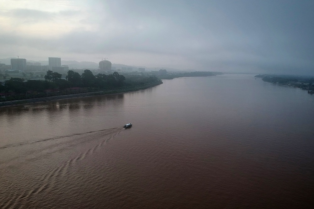This aerial photo taken on September 20, 2019 shows a boat passing through the Mekong River along the Thai side (right) showing Chiang Rai province and the Laos side of the Golden Triangle. u00e2u20acu201d AFP pic  
