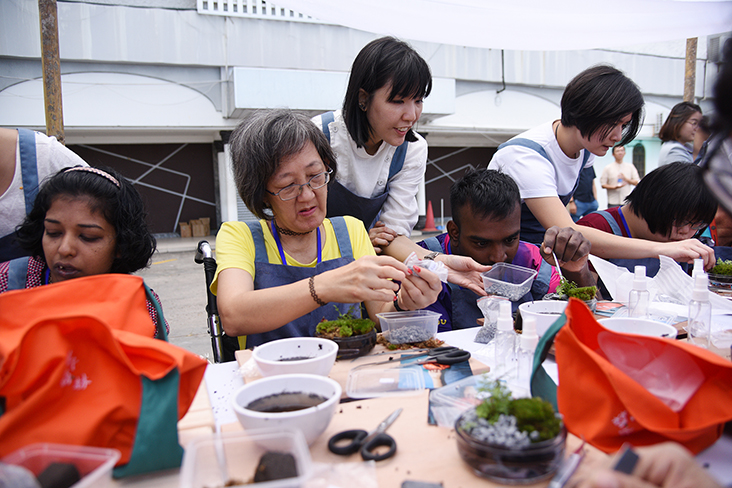 Ivy Gan (second from left) making her own miniature forest in a bottle at the workshop