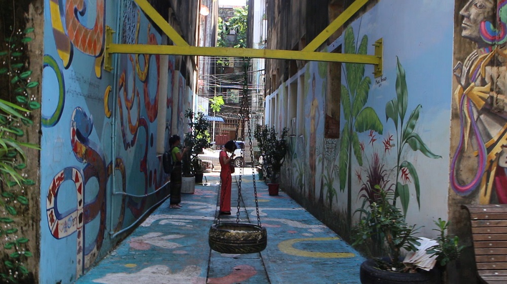 Visitors taking pictures at one of the back alleys that have been upgraded with the help of Doh Eain in downtown Yangon, Myanmar November 1, 2019. u00e2u20acu201d Thomson Reuters Foundation pic