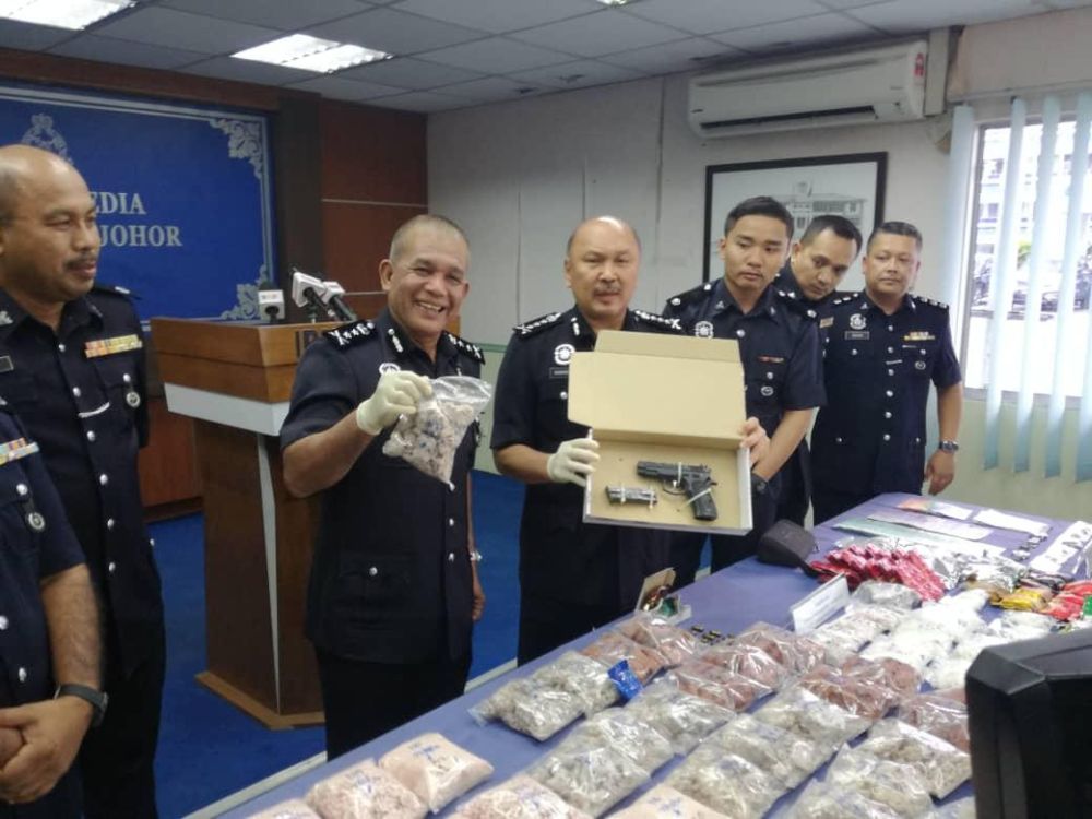 Johor police chief Datuk Mohd Kamarudin Md Din (centre) with the items seized from the drug trafficking syndicate in Johor Baru January 23, 2020. u00e2u20acu201d Picture by Ben Tannn