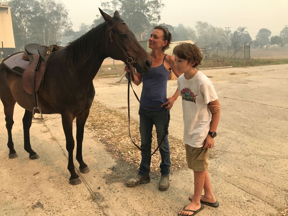 Bec Winter stands next to her son, Riley, and her horse Charmer, who she rode to safety through bushfires on New Yearu00e2u20acu2122s Eve, in Moruya, Australia January 4, 2020. u00e2u20acu201d Reuters pic