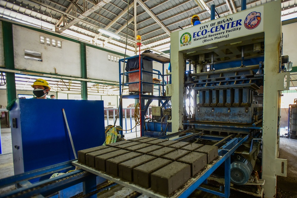 In this photo taken on January 17, 2020, workers at the Binan City Materials and Recovery Facility monitor the brick making process from collected volcanic ash from the Taal volcano eruption to process and turn into cement bricks in Bian. u00e2u20acu201d AFP pic  