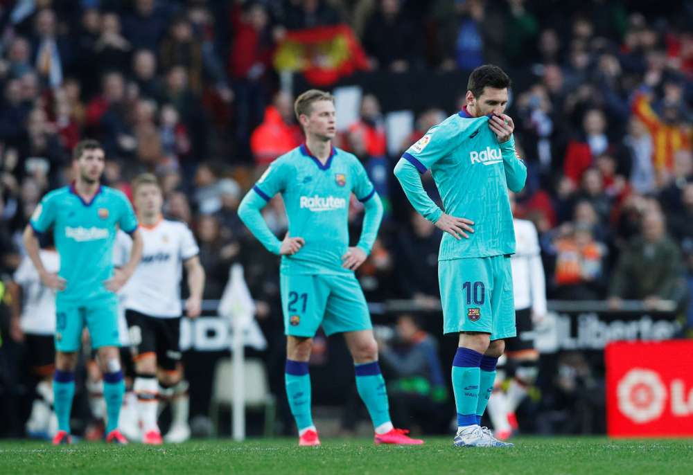 Barcelona's Lionel Messi and Frenkie de Jong look dejected after Maxi Gomez scored Valencia's second goal, January 25, 2020. u00e2u20acu2022 Reuters pic