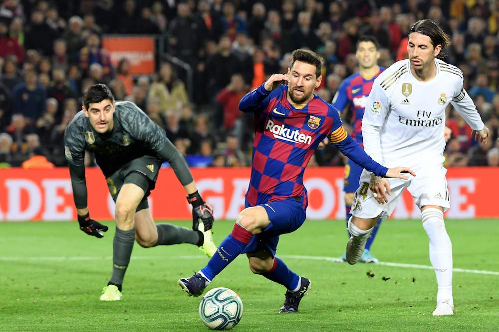 Real Madridu00e2u20acu2122s Sergio Ramos challenges Barcelonau00e2u20acu2122s Lionel Messi next to Real Madridu00e2u20acu2122s goalkeeper Thibaut Courtois during the u00e2u20acu02dcEl Clasicou00e2u20acu2122 at Camp Nou in Barcelona December 18, 2019. u00e2u20acu201d AFP pic
