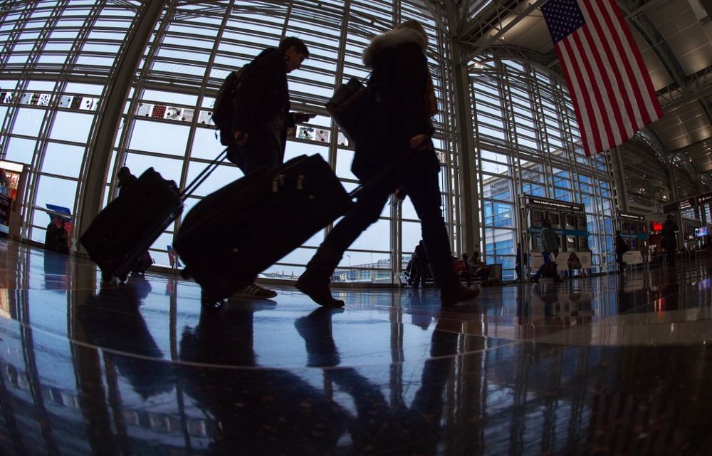 In this file photo taken on November 26, 2014, airline travellers at Ronald Reagan National Airport walk to a Transportation Security Administration (TSA) security checkpoint prior to travelling. u00e2u20acu201d AFP pic