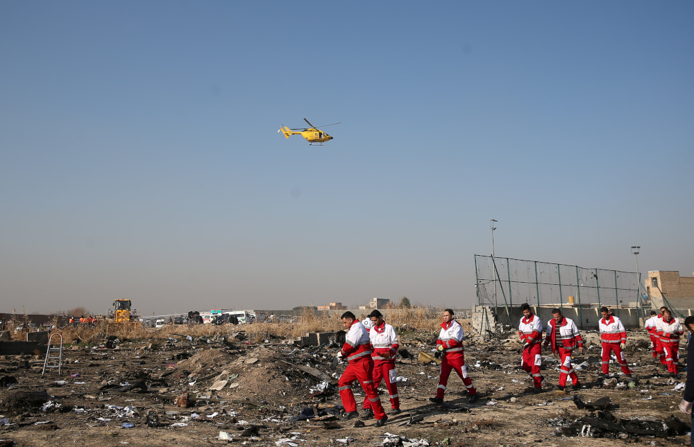 Rescue teams work among debris of a plane belonging to Ukraine International Airlines that crashed after take-off from Iranu00e2u20acu2122s Imam Khomeini airport, on the outskirts of Tehran, Iran January 8, 2020. u00e2u20acu201d Nazanin Tabatabaee/WANA (West Asia News Agency) pi