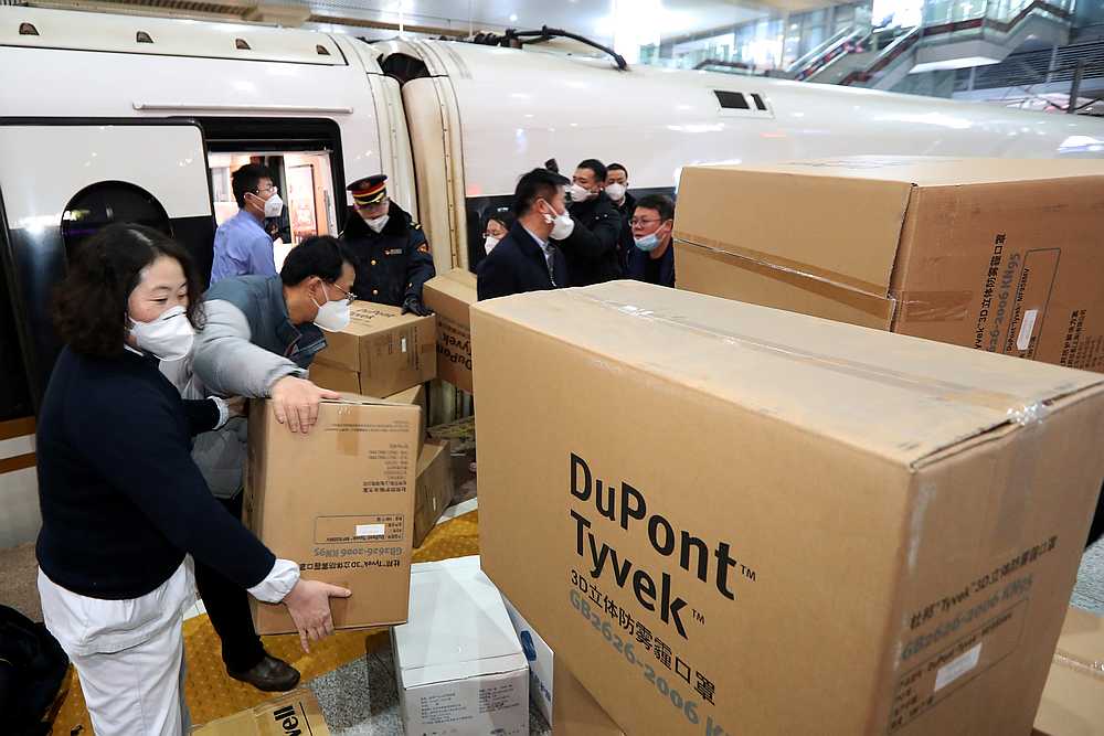 Medical and railway station staff members load boxes of protective masks and other supplies onto a train to Wuhan at the Nanjing Railway Station, in Jiangsu province, China January 25, 2020. u00e2u20acu201d cnsphoto via Reuters