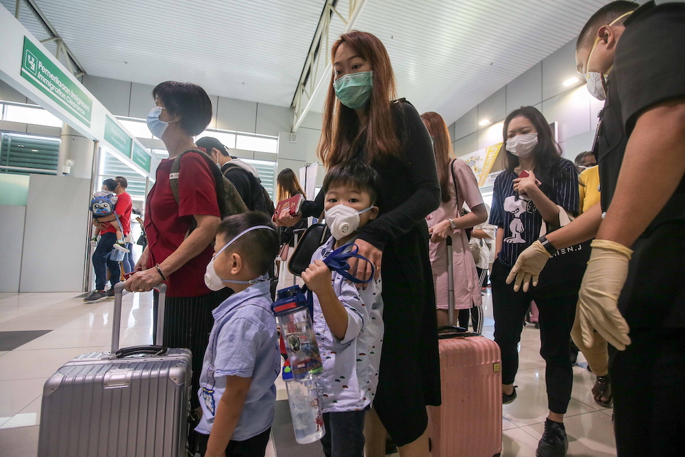 Visitors in face masks land at Sultan Azlan Shah Airport in Ipoh January 30, 2010. — Picture by Farhan Najib