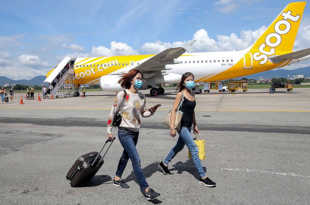 Visitors in face masks land at Sultan Azlan Shah Airport in Ipoh January 30, 2010. u00e2u20acu201d Picture by Farhan Najib