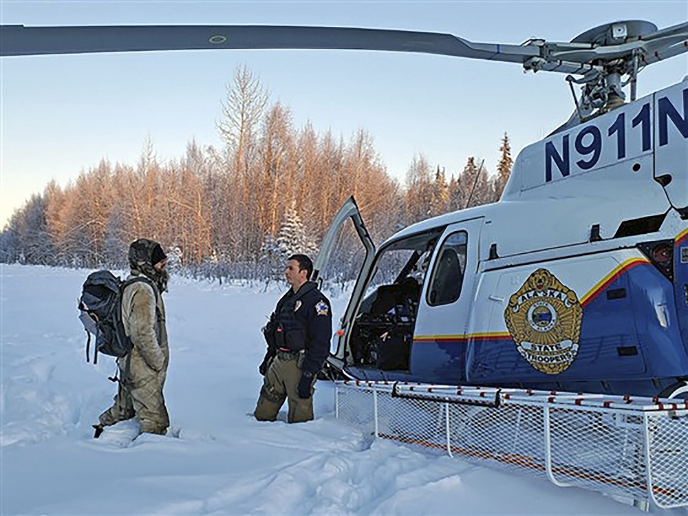 This handout photo obtained January 12, 2020, shows an Alaska State Trooper speaking with Tyson Steele, who was rescued after 20 days in subzero temperatures after his cabin in the remote Susitna Valley burned down. u00e2u20acu2022 Alaska State Troopers/AFP pic