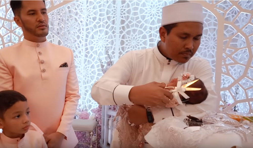 Aliff watches on as the preacher cuts Raudhah’s hair. — Screengrab via Youtube/TV Terlajak Laris