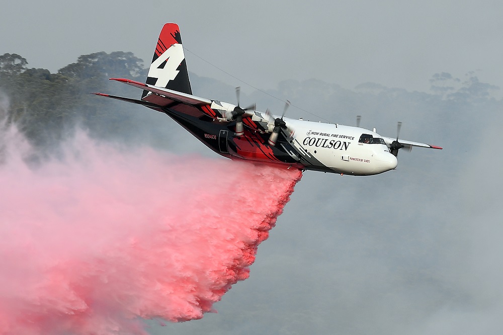 This file photo taken on January 10, 2020 shows a C-130 Hercules plane from the New South Wales Rural Fire Service dropping fire retardent to protect a property during an operation to douse bushfires in Penrose, in Australia;s New South Wales. u00e2u20acu201d AFP pic