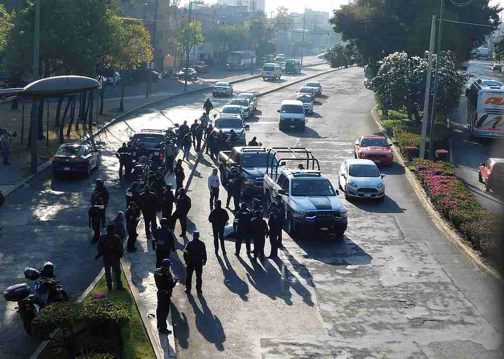 Police officers gather at a crime scene around a body which was wrapped in tape and blankets and left by unknown assailants in the middle of a street in Mexico City January 14, 2020. u00e2u20acu201d Reuters pic