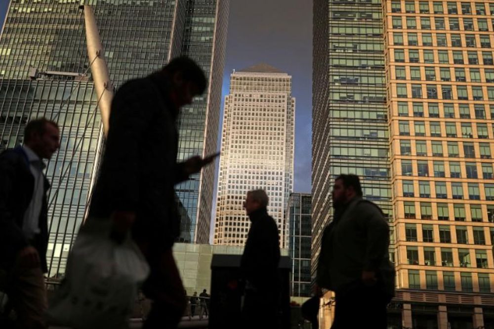 People walk through the Canary Wharf financial district of London, Britain, December 7, 2018. u00e2u20acu201d Reuters file pic