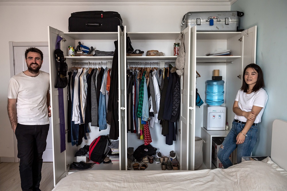 Carrie Yu and Joe Harvey, founders of zero-waste shop The Bulk House, pose beside their wardrobe at their home in Beijing. u00e2u20acu201d AFP pic 