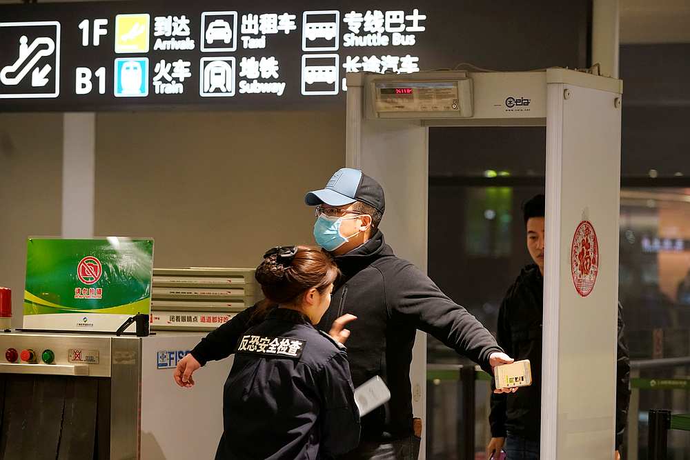 A passenger wearing a mask is seen at Hongqiao International Airport in Shanghai, China January 20, 2020. u00e2u20acu201d Reuters picn