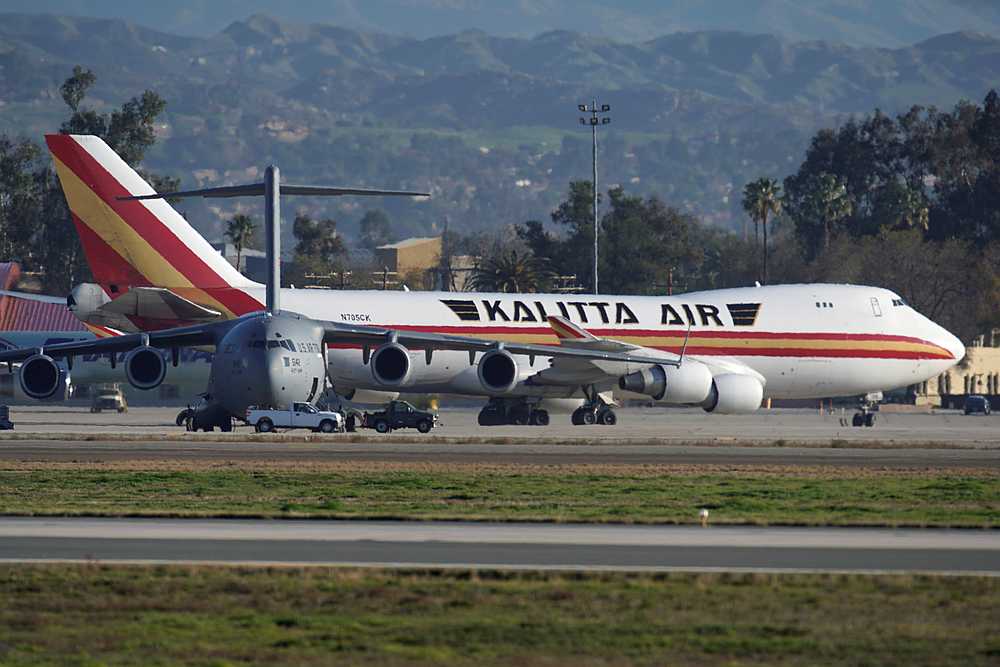 A US State Department chartered aircraft to evacuate Americans in Wuhan, passes a military transport plane at March Air Reserve Base in Riverside County, California January 29, 2020. — Reuters pic