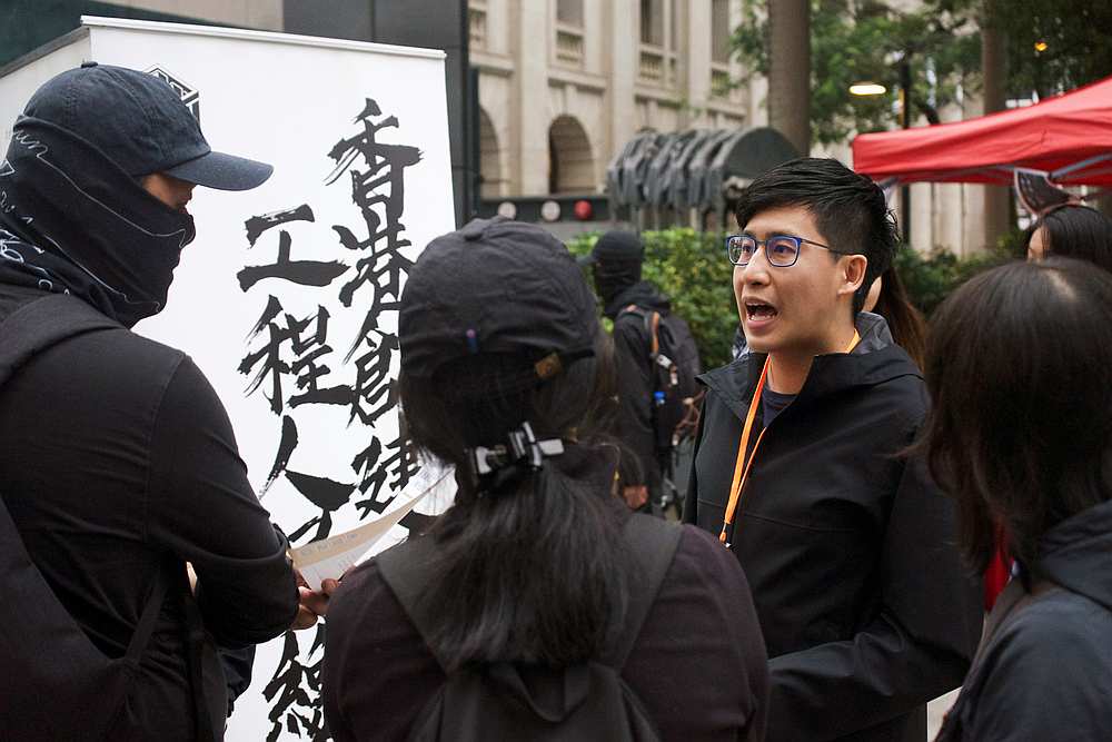 Chris Ngai, Hong Kong Construction and Engineering Employees General Union chairman, talks to people near his recruitment booth in Hong Kong January 1, 2020. u00e2u20acu201d Reuters pic