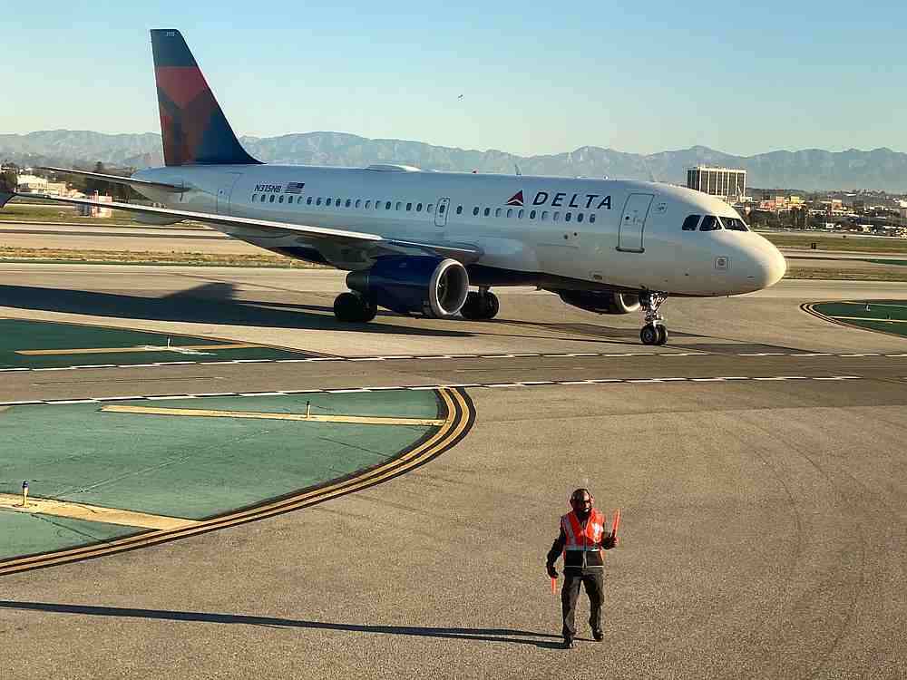 An airport worker guides a Delta Air Lines Airbus A319-100 plane on the tarmac at LAX in Los Angeles, CaliforniaJanuary 6, 2020. u00e2u20acu201d Reuters pic