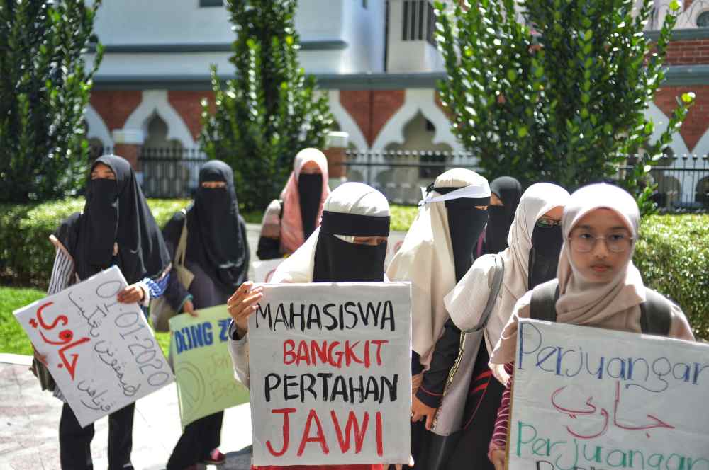 Protesters hold placards as they staged a peaceful protest in Kuala Lumpur January 1, 2020. ― Picture by Shafwan Zaidon  