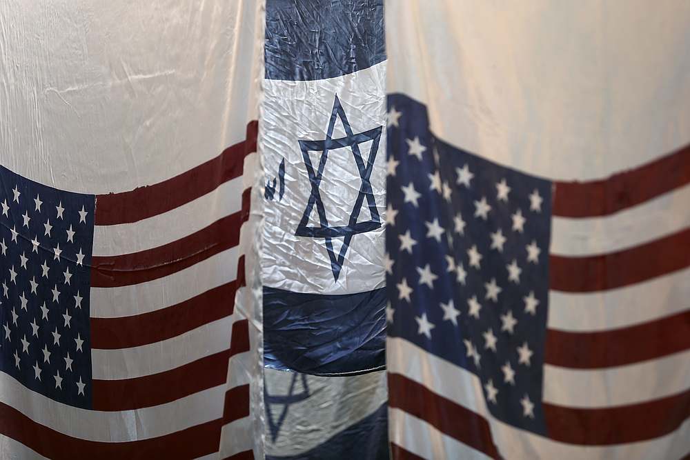 US and altered Israeli flags hang at a large flag factory which creates them for Iranian protesters to burn in Khomein City, Iran January 28, 2020. u00e2u20acu201d Wana pic via Reuters