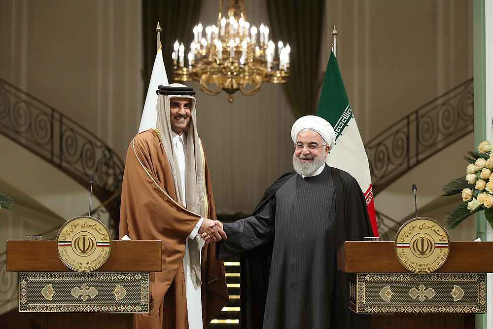 Iranian President Hassan Rouhani shakes hands with Emir of Qatar Sheikh Tamim bin Hamad bin Khalifa Al-Thani, during a news conference in Tehran, Iran January 12, 2020. Official Iranian Presidential Website handout via Reuters 