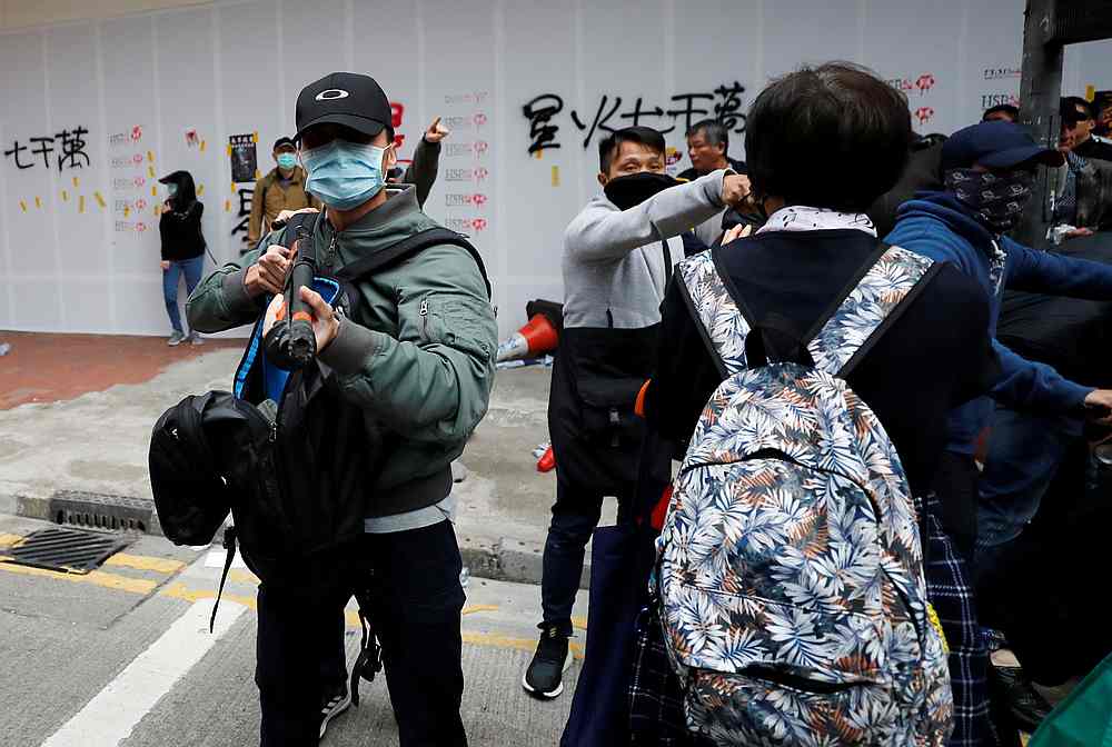 A plainclothes police officer holds a weapon to disperse anti-government protesters during a demonstration on New Year's Day in Hong Kong January 1, 2020. u00e2u20acu201d Reuters pic