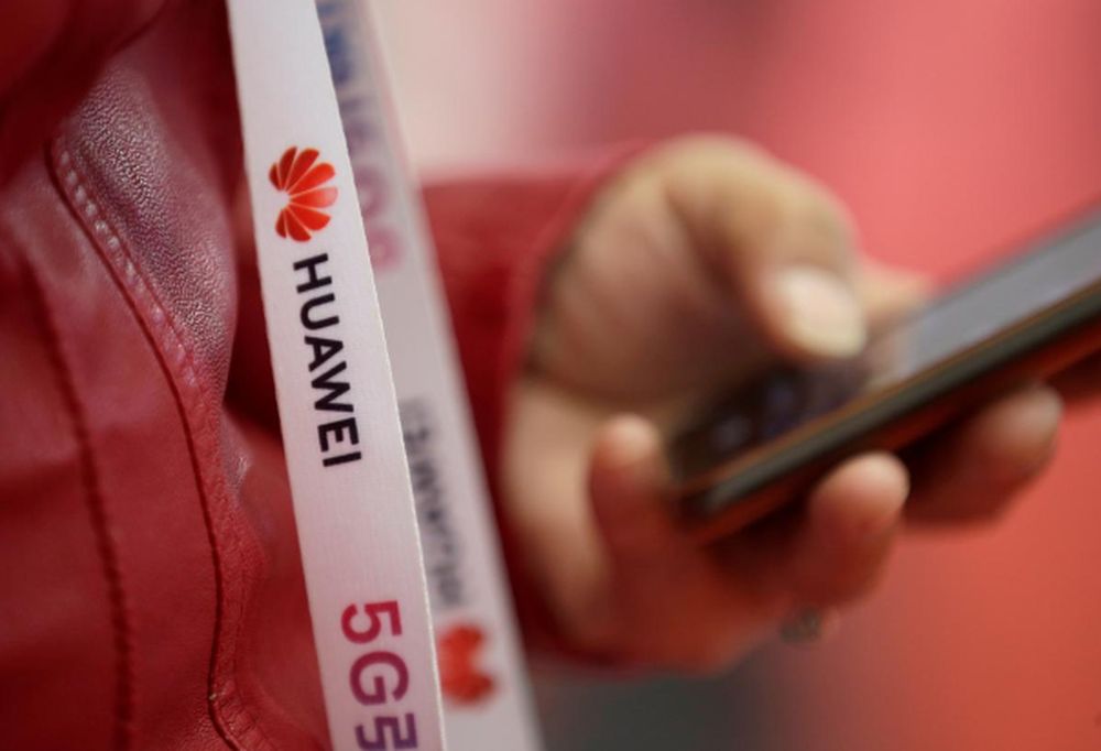 An attendee wears a badge strip with the logo of Huawei and a sign for 5G at the World 5G Exhibition in Beijing, China November 22, 2019. u00e2u20acu201d Reuters file pic