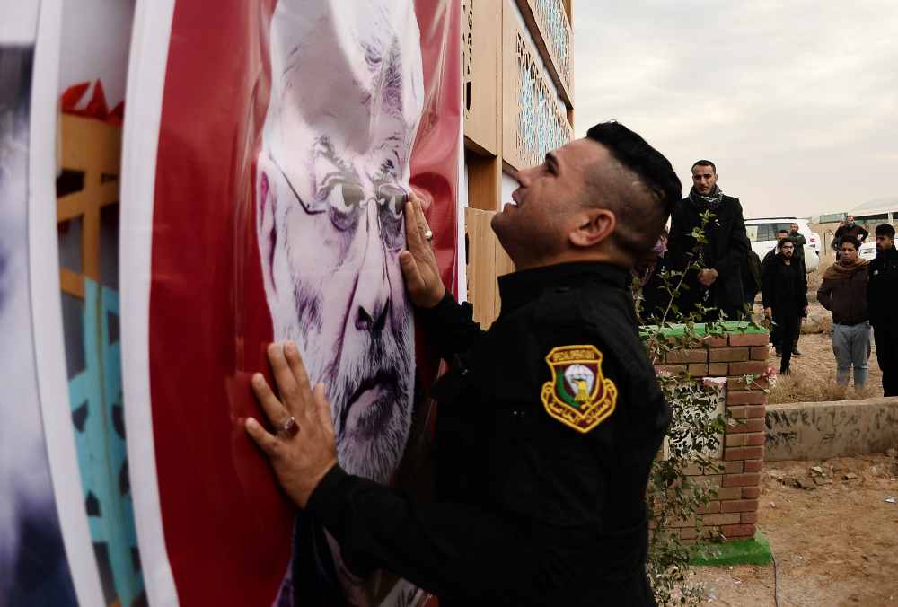 A member of Iraqu00e2u20acu2122s special force sheds tears in front of a portrait of the slain chief of the Hashed al-Shaabi paramilitary network, Abu Mahdi al-Muhandis, ahead of his burial in Najaf January 8, 2020. u00e2u20acu201d AFP pic 