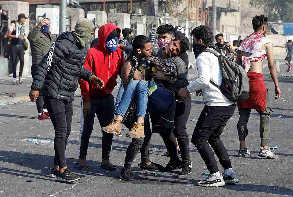 Iraqi demonstrators carry away a man affected by tear gas during ongoing anti-government protests, in Baghdad, Iraq January 20, 2020. u00e2u20acu201d Reuters pic