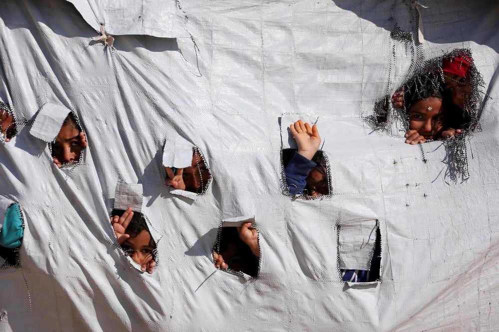 Children look through holes in a tent at al-Hol displacement camp in Hasaka governorate, Syria April 2, 2019. u00e2u20acu201d Reuters pic