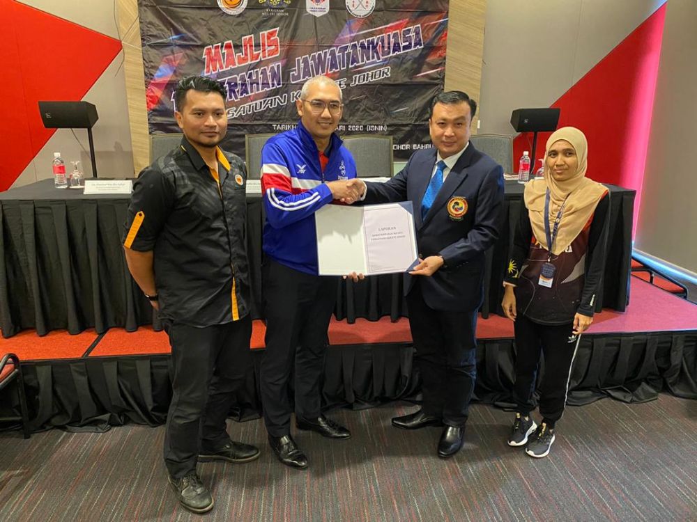 Johor Sports Council director Mohd Gadaffie Abd Aziz (second from left) handing over the Johor Karate Associationu00e2u20acu2122s ad-hoc committee report to the associationu00e2u20acu2122s new chairman Chok Kong Yu in Johor Baru. u00e2u20acu201d Picture by Ben Tan