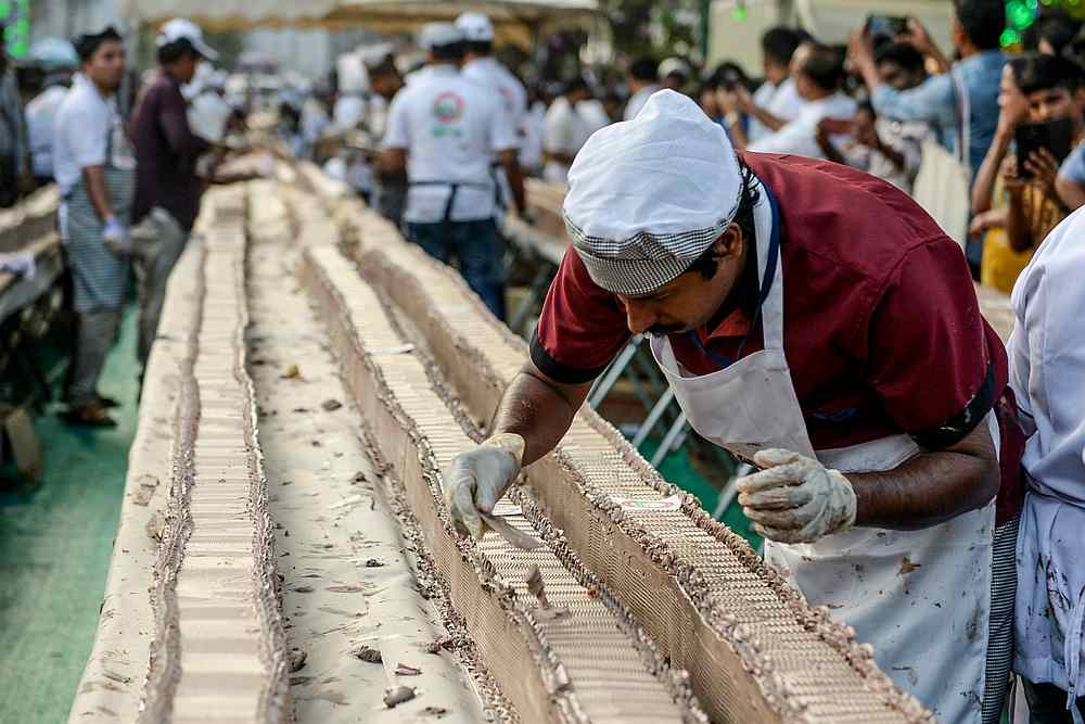 A baker prepares an approximately 6.5-km long cake in an attempt aim to break the Guinness World Record for the longest cake, in Thrissur in the south Indian state of Kerala on January 15, 2020. u00e2u20acu201d AFP pic